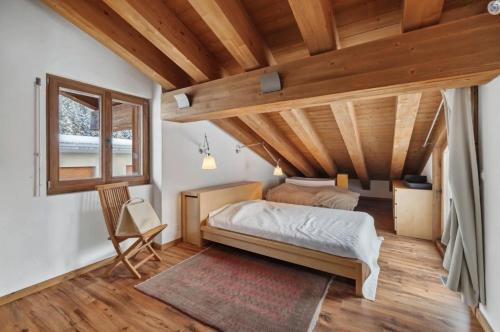 a bedroom with a bed and a wooden ceiling at Magnificent flat in Crans-Montana - 856 in Crans-Montana