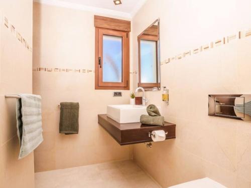 a bathroom with a sink and a mirror at Casa Orquídea in Jávea