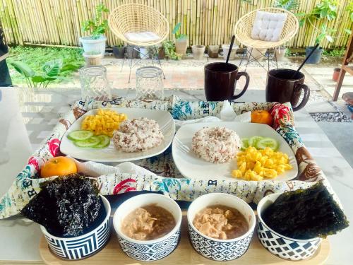 a tray with plates of food on a table at Balai Lawaan Charming Sanctuary in Iloilo City