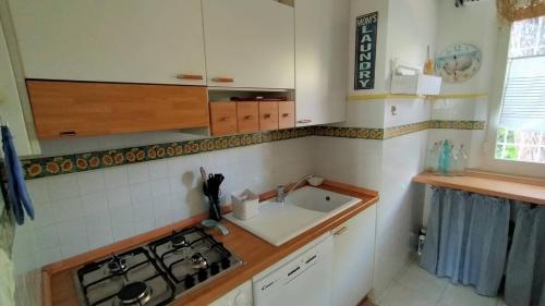 a small kitchen with a stove and a sink at Villa Girasoli - Taunus Vacanze in Numana