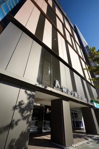 a building with a sign on the side of it at K Hotel Taipei Nanjing in Taipei
