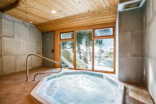 a hot tub in a room with a window at Sierra Del Sol 6 in Taos Ski Valley