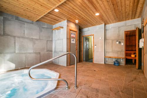 a hot tub in a room with a wooden ceiling at Sierra Del Sol 36 in Taos Ski Valley