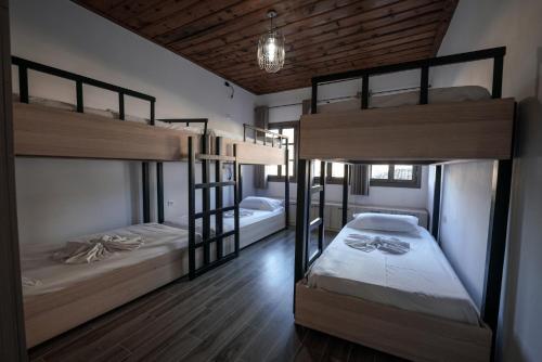 two bunk beds in a room with wooden floors at Helin's Hostel by Backpackers in Berat