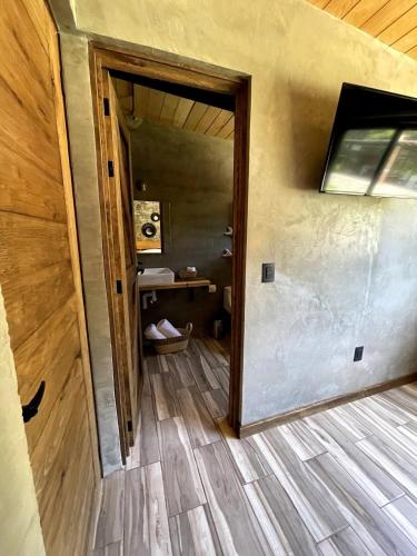 an open door to a room with a wooden floor at Cabaña Buganvilia, Tapalpa in Tapalpa