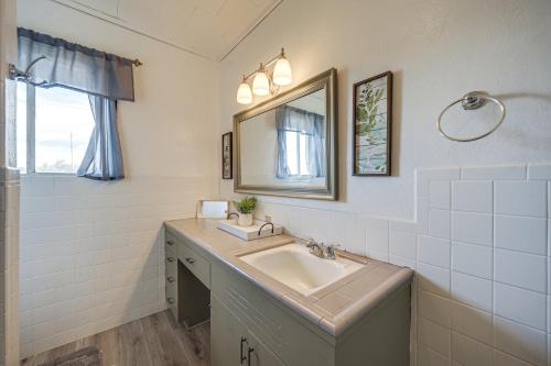 a bathroom with a sink and a mirror at Rustic and Western House on Lake - Swim, Fish, Hunt! in Llano