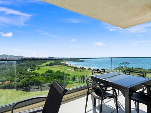 a balcony with a table and chairs and a view of the ocean at Fourteen at Mullet Bay in Cupecoy