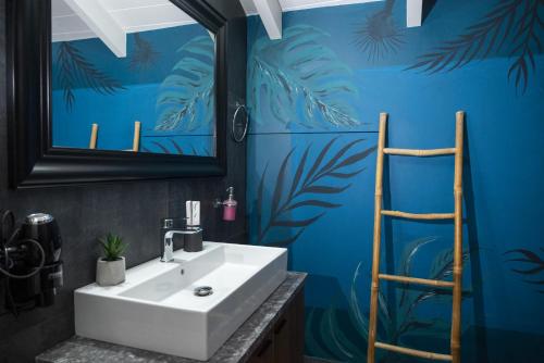 a bathroom with a white sink and a blue wall at Deisisroom nafplio poseidon in Nafplio