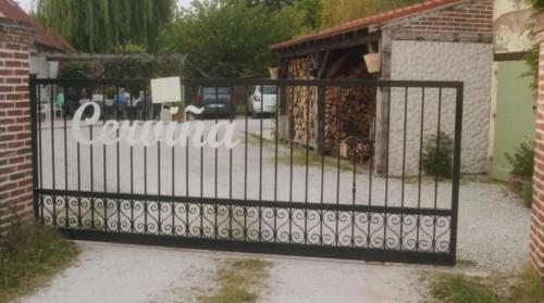 Una puerta de hierro negra con un cartel. en Chambres et Table d'hôtes Cerviña, en Châteauneuf-sur-Loire