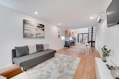 a living room with a couch and a table at Fornos Deluxe Apartments in Lisbon