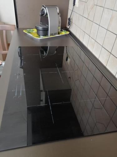 a kitchen counter with a sink and a toaster at Casa Alpamar in Villasimius