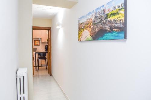 a hallway with a painting hanging on a wall at Your Home, in the center of Bari in Bari