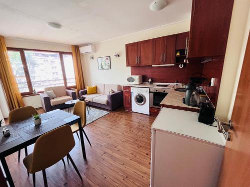 a kitchen and living room with a table and a kitchen and a living room at Mountain Cedar Pine 1 BR Apt near Ski Gondola in Bansko