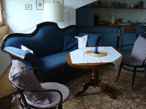 a living room with a couch and a table with a candle at Odenwaldblick Michelstadt in Michelstadt
