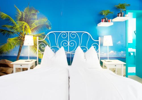 a bedroom with two beds and a palm tree at Arena Lodge in Flims