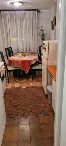 a kitchen with a table and chairs and a refrigerator at Grey apartment Novi Beograd in Belgrade