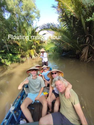 a group of people riding in a boat on a river at Song Ngư Riverside Homestay in Can Tho
