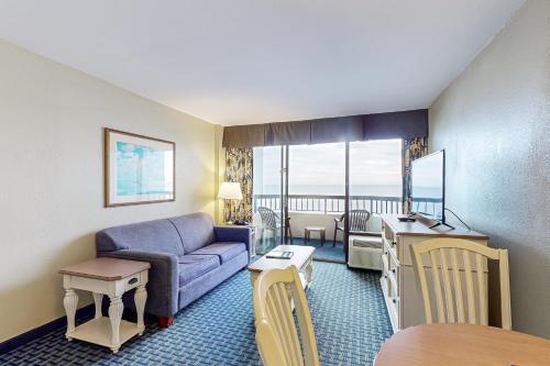 a living room with a couch and a table at Compass Cove 655 in Myrtle Beach