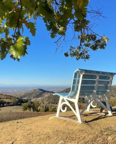 a blue and white chair sitting on top of a hill at Hotel Milano Pool & Garden in Salice Terme