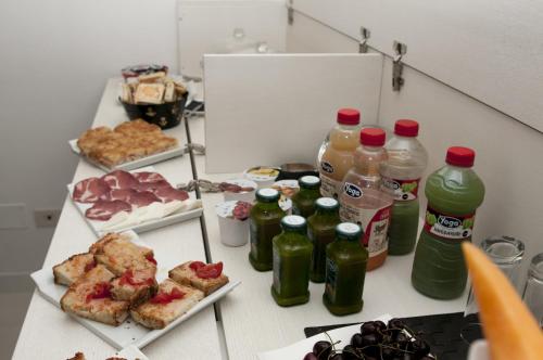 a table with food and bottles of drinks on it at Edificio 15 House Elite in Rodi Garganico