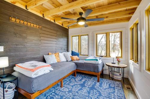 a room with two beds and a ceiling fan at Cozy Steelville Retreat River and Trail Access! in Steelville