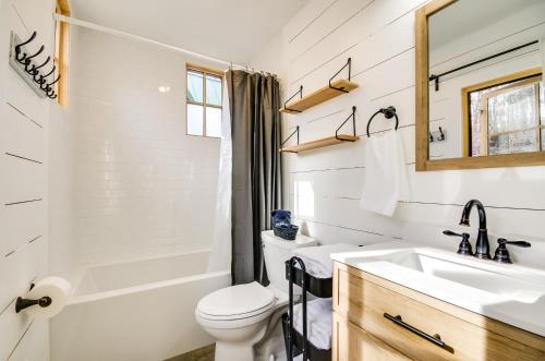 a white bathroom with a sink and a toilet at Cozy Steelville Retreat River and Trail Access! in Steelville