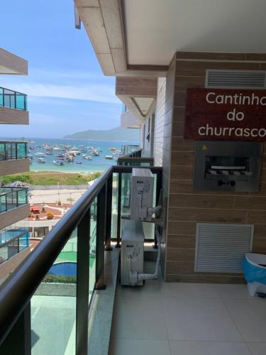 a balcony of a building with a view of a harbor at apartamento de frente para o mar com linda area de lazer in Arraial do Cabo