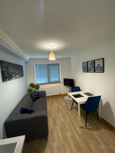 a living room with a couch and a table at Stylish 1 bedroom apartment in Norwich city centre in Norwich