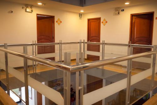 a staircase in a building with a metal railing at Real House Cusco in Cusco