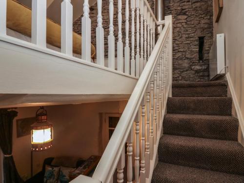 a staircase in a home with a stone wall at Still Waters in Ulverston