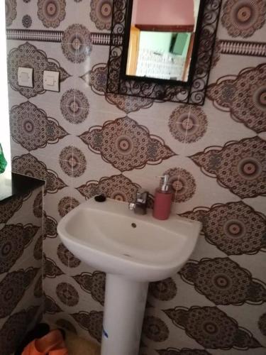 a bathroom with a sink and a mirror at Dar rachid ouzoud in Azilal