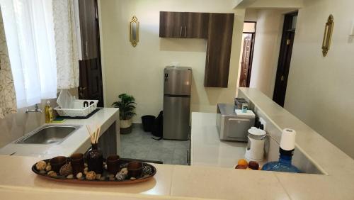 a kitchen with a plate of food on a counter at Twin Palms Apartments, Bamburi, Mombasa in Mombasa