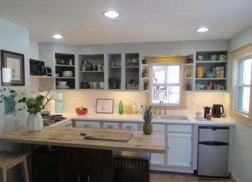 a kitchen with white cabinets and a wooden counter top at 2 bedroom Apt in Kingston