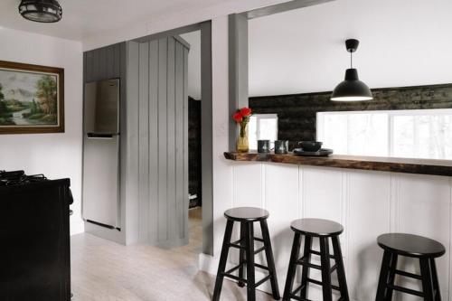 a kitchen with two bar stools and a refrigerator at 2409 - Oak Knoll #11 cabin in Big Bear Lake