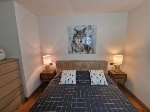 a bedroom with a bed and a picture of a wolf at MB26 in Courmayeur