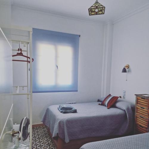 a bedroom with a bed and a window at La Casona de Alba in Encinasola