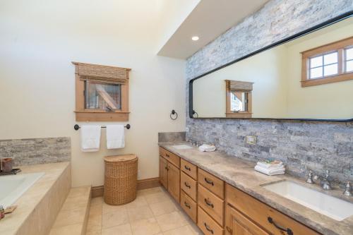 a bathroom with two sinks and a large mirror at Telemark B by AvantStay Ski In Ski Out at the Heart of Mountain Village in Telluride