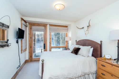 a bedroom with a large bed and a window at Telemark B by AvantStay Ski In Ski Out at the Heart of Mountain Village in Telluride