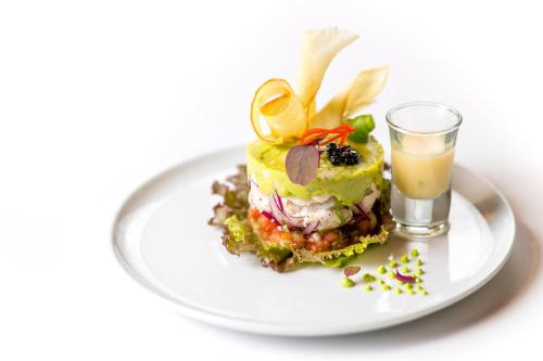 a dessert on a white plate with a glass of orange juice at Hideaway Rio Celeste Hotel in Bijagua