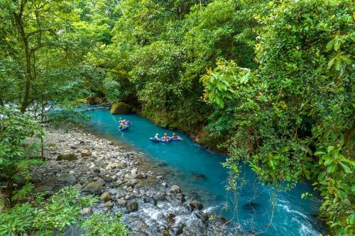 a group of people rafting down a river at Hideaway Rio Celeste Hotel in Bijagua