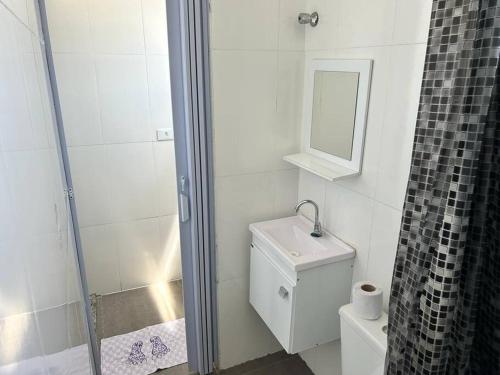 a bathroom with a shower and a toilet and a mirror at Studio proximo Expo Center Norte bairro Vila Guilherme São Paulo in São Paulo