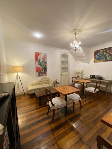 a living room with a table and chairs and a couch at Castelletto Bed & Breakfast in Santiago