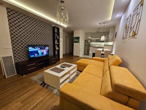 a living room with a couch and a television at West 65 apartment in Belgrade