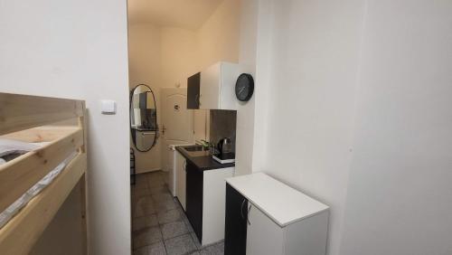 een kleine badkamer met een wastafel en een klok aan de muur bij Small apartment for groups in city centre in Praag