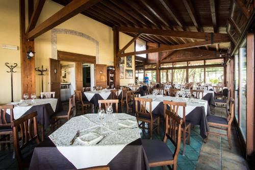 a restaurant with tables and chairs in a room at Antica Stazione in Chiaramonte Gulfi