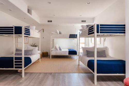 a bedroom with two bunk beds with blue and white at Julep by AvantStay Stylish 9 BR Estate w Mid-Century Modern Decor in Phoenix