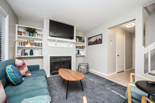 a living room with a blue couch and a fireplace at Luxurious Extended Stay Dream~3 Kings~Desks~TV's in Snellville
