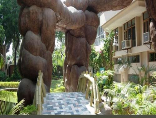 a stone archway in a building with a stone wall at Ananda Krishna Van in Vrindāvan