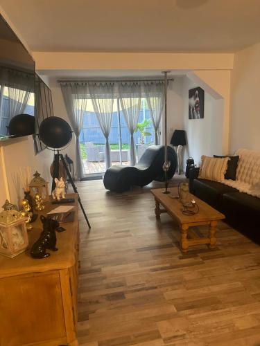a living room with a couch and a table at La Maison des Plaisirs Love room in Champigny-sur-Yonne