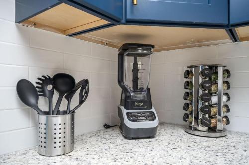 a blender sitting on top of a counter with utensils at Luxurious Extended Stay Dream~3 Kings~Desks~TV's in Snellville